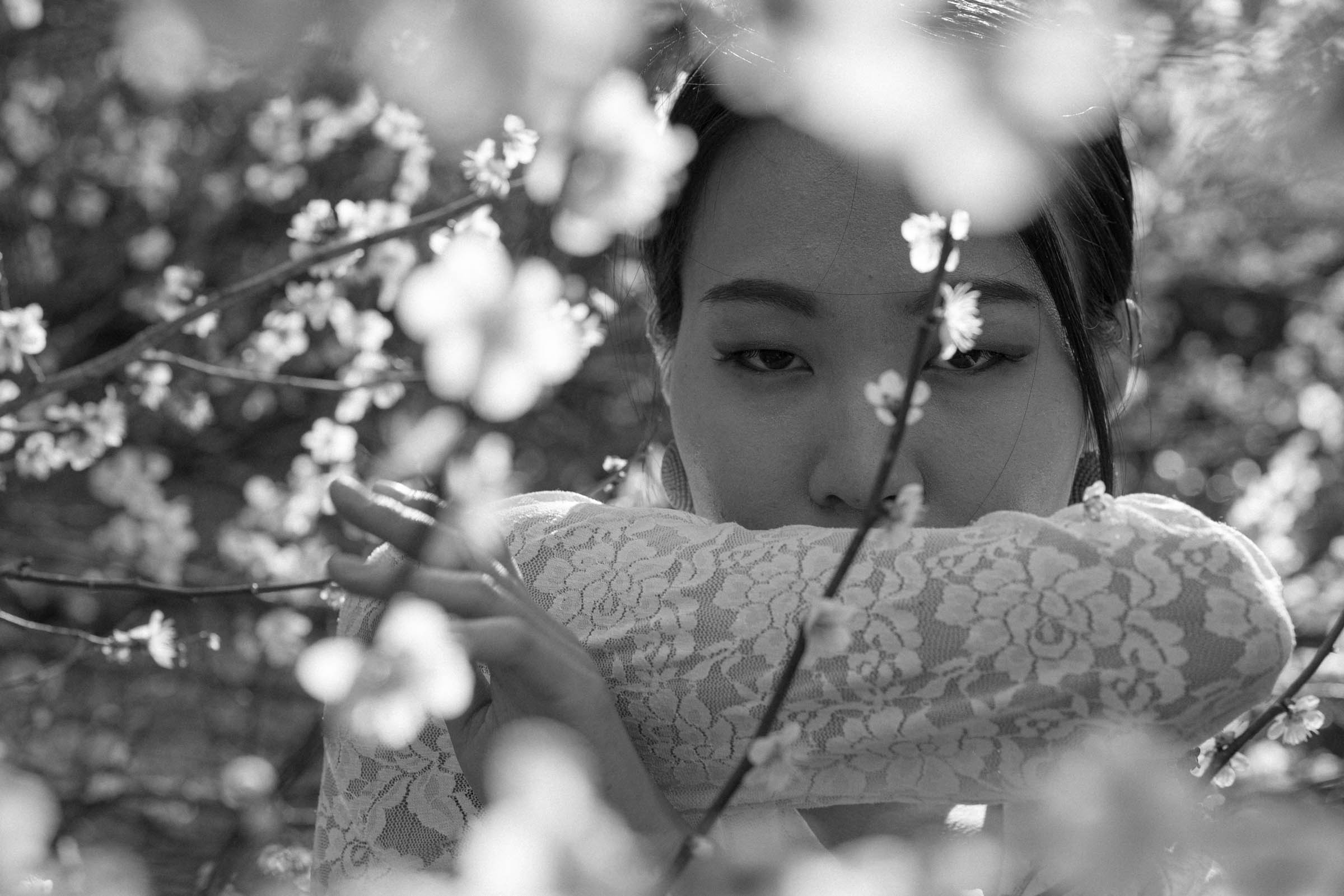 ayaをモデルに、和田剛が撮影したポートレート作品「somewhere」。季節の花とモデルを撮影したモノクロームの人物写真。